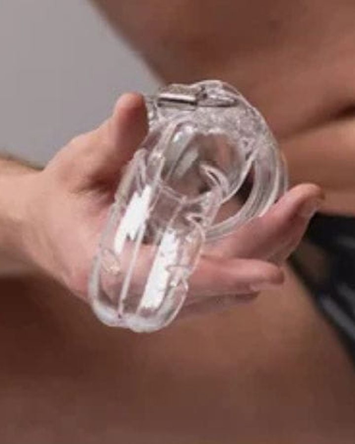 Man holding a transparent chastity cage – chastity cage India